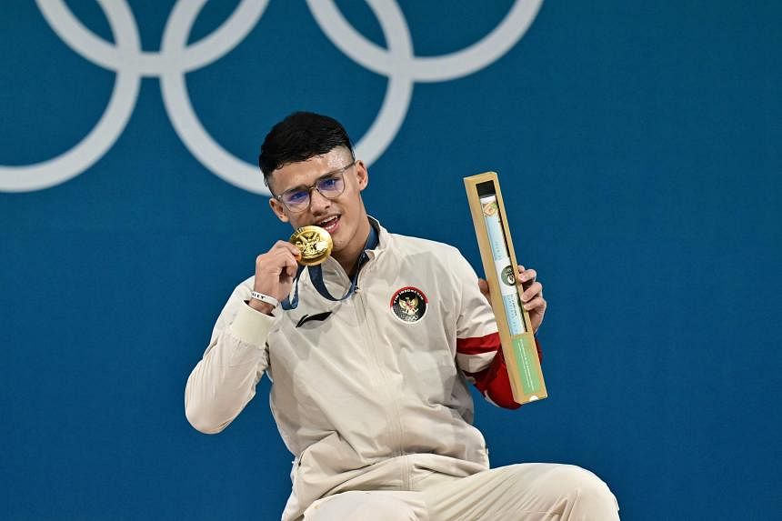 Indonesia’s Rizki Juniansyah wins men’s 73kg weightlifting gold medal