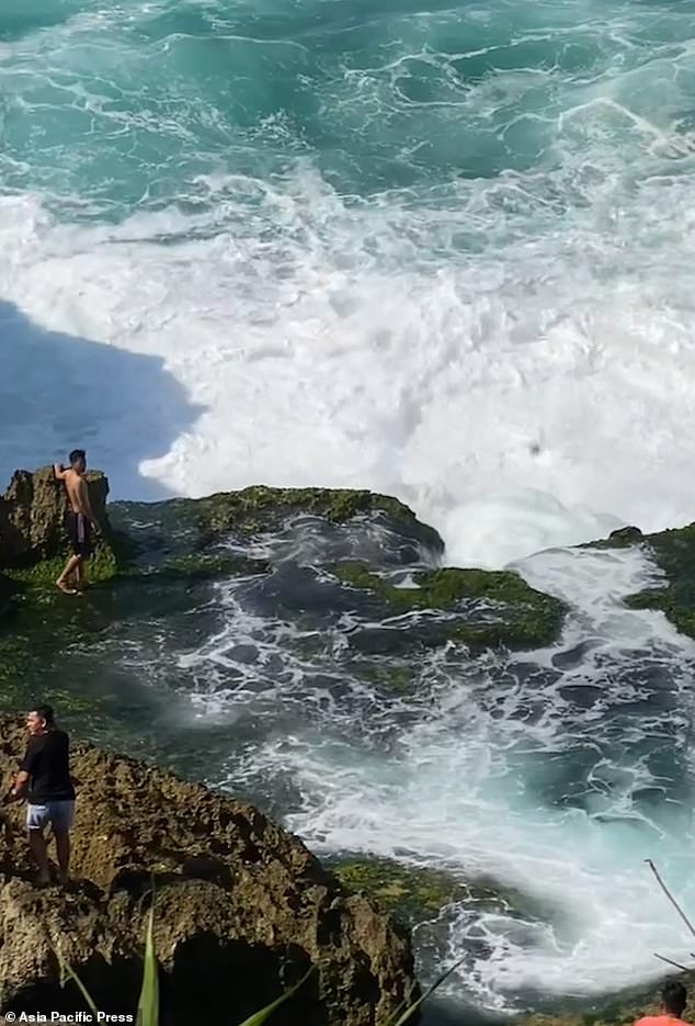 Rony Josua Simanjuntak, 21, from North Sumatra, was standing on wet rocks before being washed away by the large wave. Pictured top left